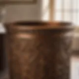 Bronze bathroom wastebasket with intricate detailing