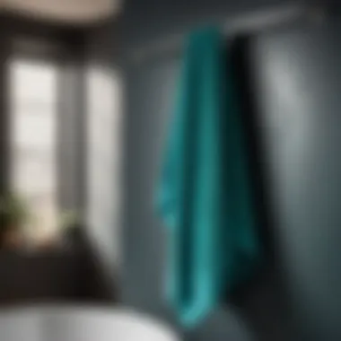 Dark turquoise bath towel hanging gracefully on a sleek bathroom hook