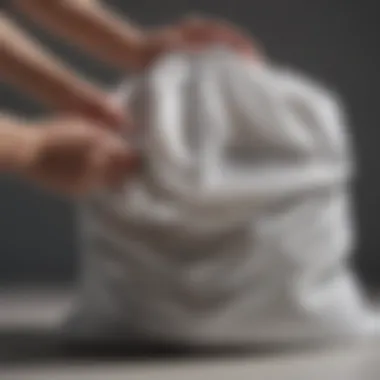 Close-up of a delicate fabric being placed inside a Bagail mesh laundry bag for protection during washing.
