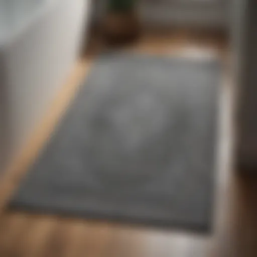 Elegant grey bathroom mat on a wooden floor