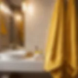 Golden yellow bath towels elegantly draped over a modern bathroom rack