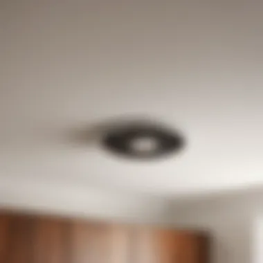 Installation process of flush mount bathroom fan in progress