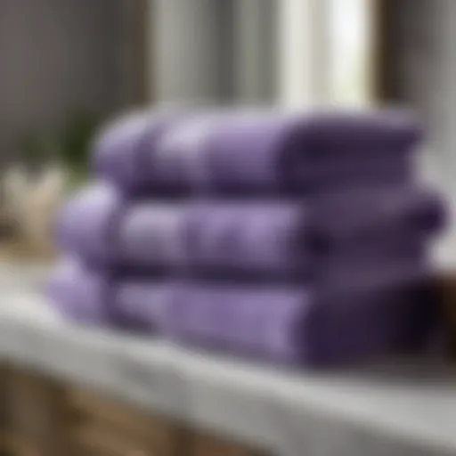 Lavender-scented violet bath towels draped over a marble countertop