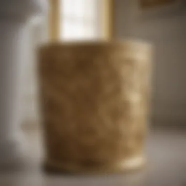 Luxurious gold-toned bathroom wastebasket with intricate design