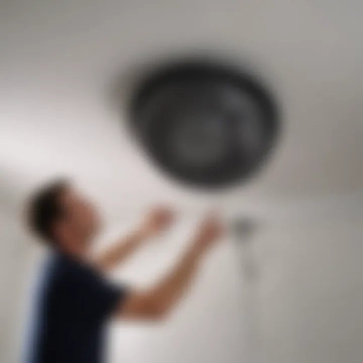 An expert installing a bathroom exhaust fan