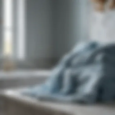 Luxurious Draping Over Marble Elegant pale blue bath towels draped over a marble countertop