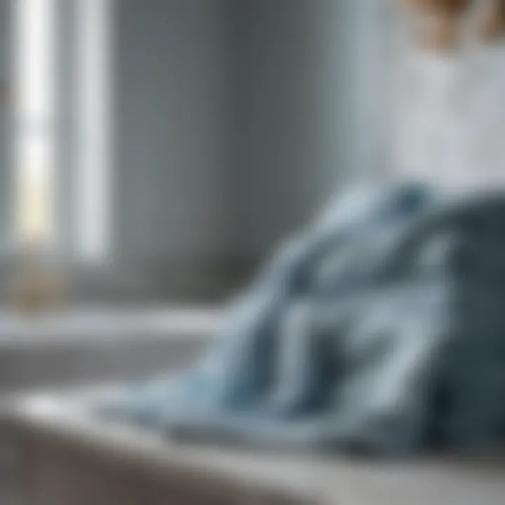 Luxurious Draping Over Marble Elegant pale blue bath towels draped over a marble countertop