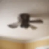 Modern bathroom exhaust fan being removed from ceiling