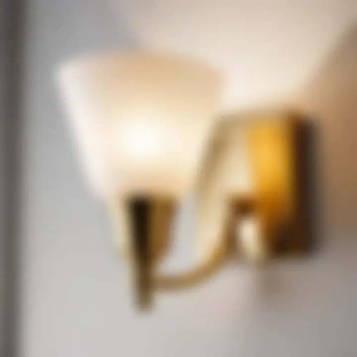 Stylish gold brass sconce illuminating a modern bathroom