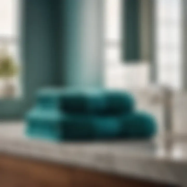 Neatly Folded Teal Blue Bath Towels on a Chic Marble Surface Teal blue bath towels neatly folded on a marble countertop