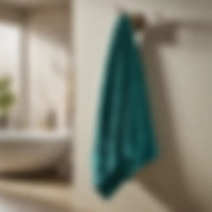 Graceful Display of Teal Blue Bath Towels on a Fashionable Hook Teal blue bath towels hanging gracefully on a stylish hook