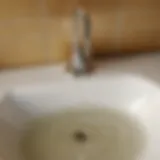 A clogged bathroom sink drain with standing water